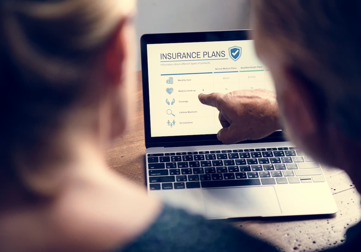 An advisor and client review the benefits of a standalone cyber insurance policy